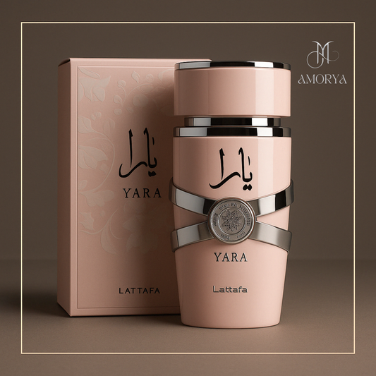Yara by Lattafa pink perfume bottle positioned in front of its floral-embossed box, featuring the Amorya silver logo on the bottle, set against a clean white background